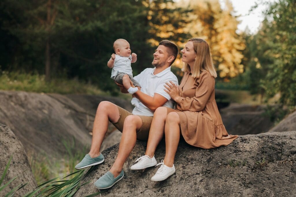 Happy family of three in the summer in the park in nature
